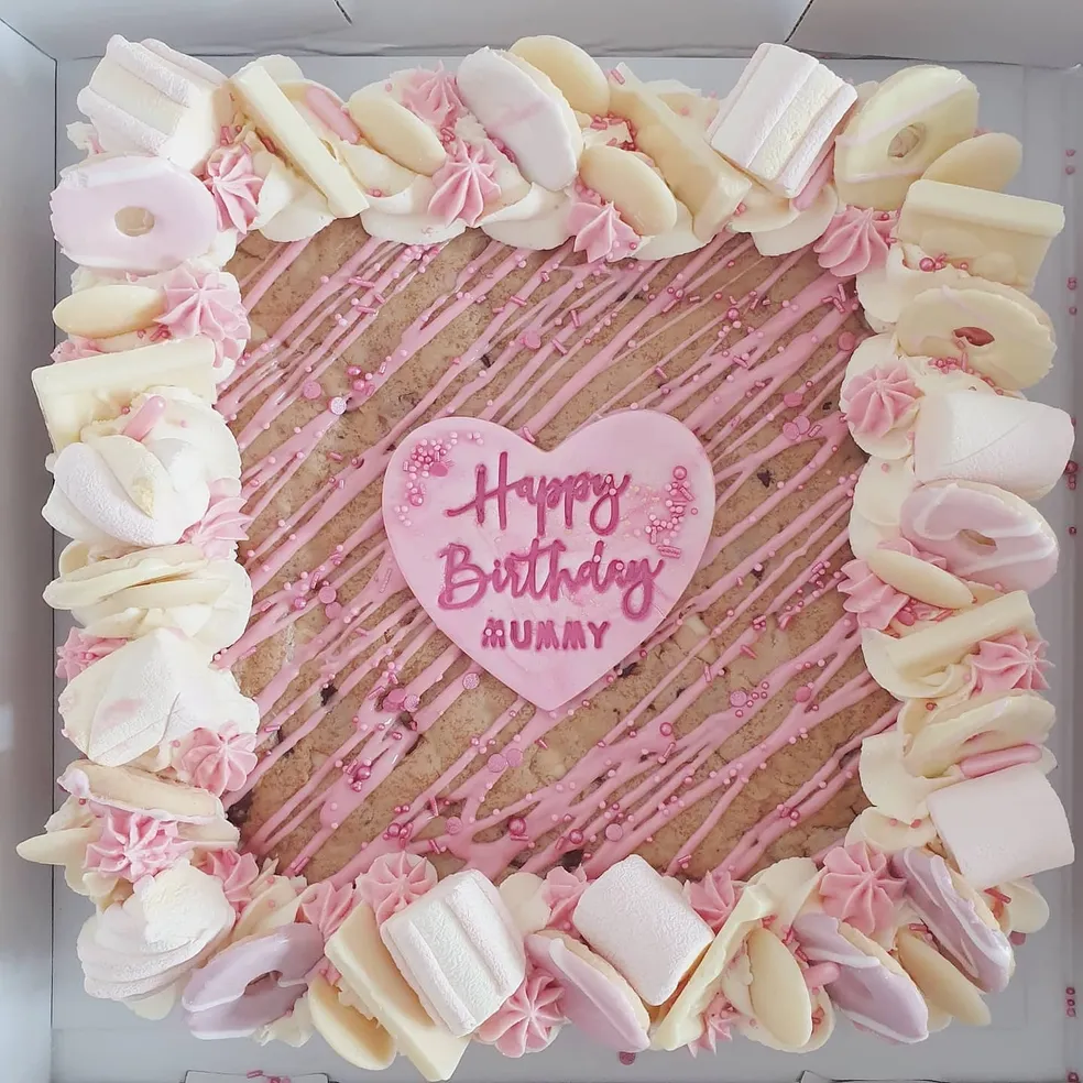 Grease themed brownie slab with Pink Ladies and T-Birds toppers, pink buttercream and sweets for 30th birthday