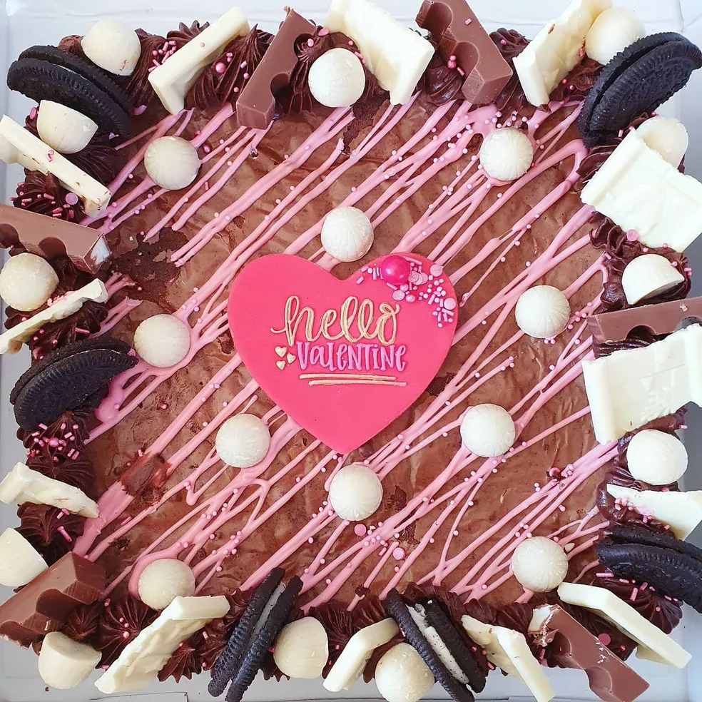 Cookie slab with white buttercream, Oreos, chocolate bars, gold Maltesers and Happy Birthday iced biscuit