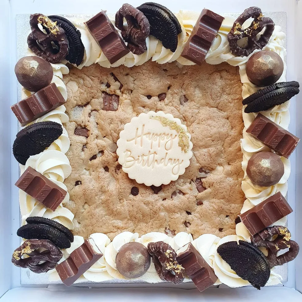 Valentine brownie slab with pink drizzle, white chocolate, Oreos and Hello Valentine heart topper