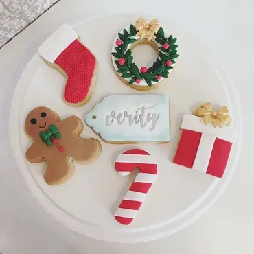 Christmas iced biscuits with stocking, wreath, gingerbread man, Verity name tag, candy cane and gift designs