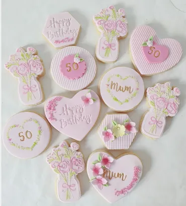 Navy and pink gender reveal baby shower iced biscuits with girl or boy, baby and onesie designs