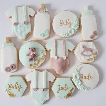 Blue and white heart-shaped wedding iced biscuits with love and T&C monogram and rose designs