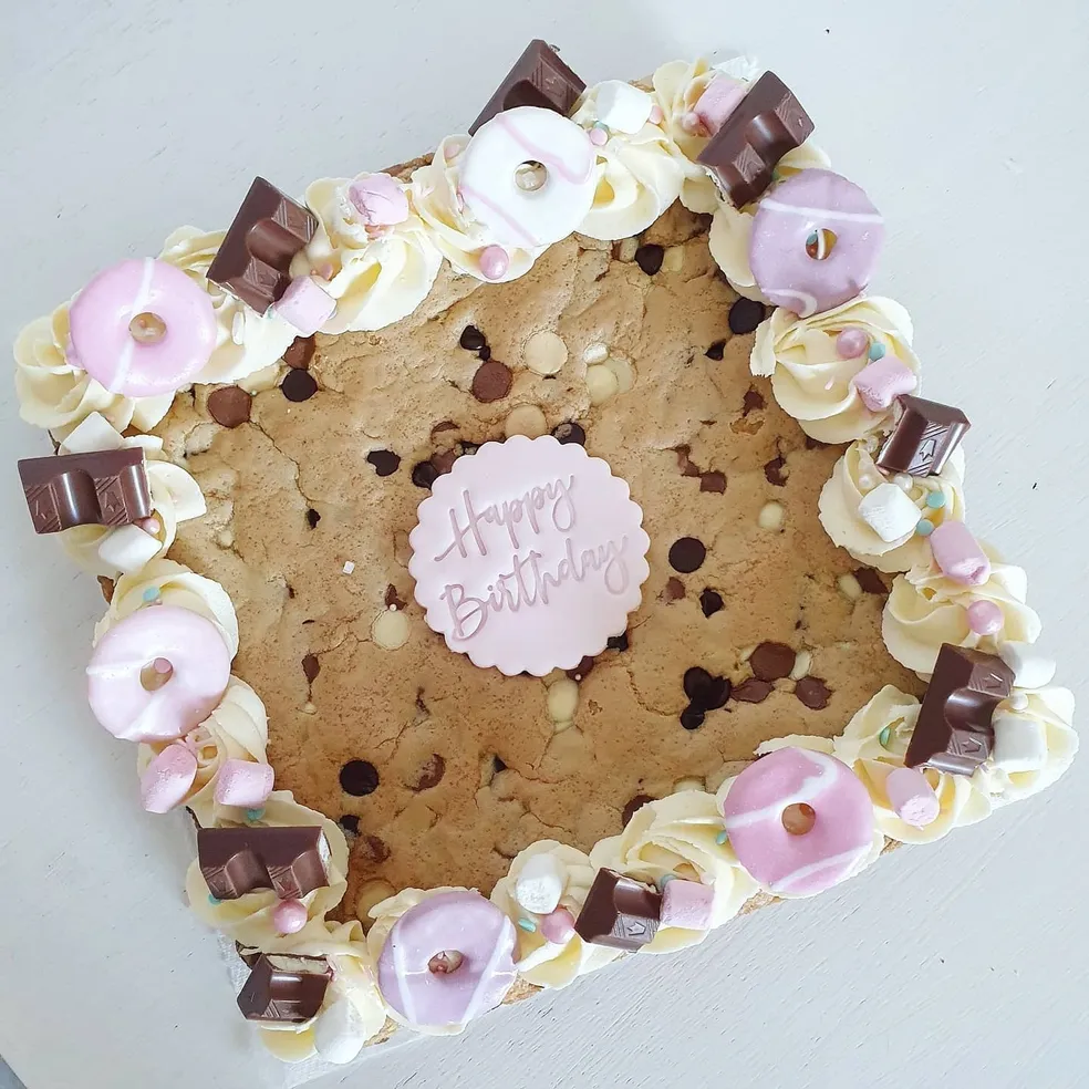 Cookie slab with pink and white buttercream rosettes, marshmallows and chocolate chunks