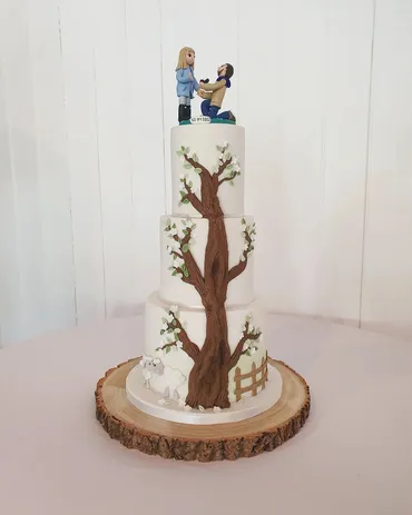 Single-tier mint green wedding cake with large pink sugar roses and white leaves