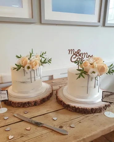 Two-tier pink ombre textured wedding cake with blush roses and gold leaf detail